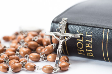 Black leather bound holy bible with rosary beads