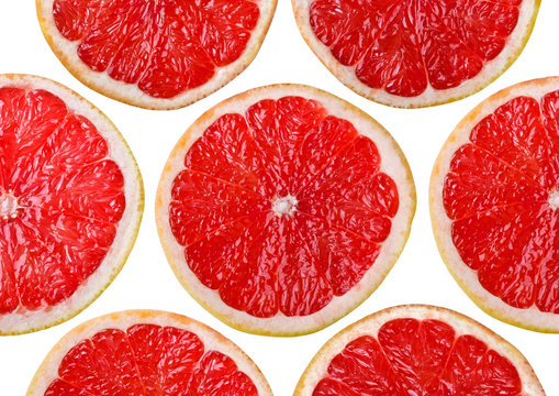 Food background - Sliced grapefruit, isolated over white