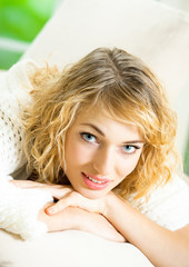 Naklejka premium Smiling young beautiful woman, indoors