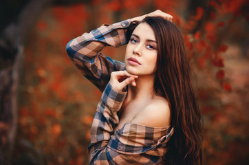 Young girl in denim shorts and a multicolored shirt