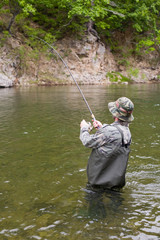 Fisherman pulls caught salmon