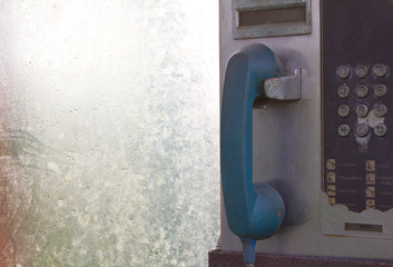 Old blue phone in phone booth coin,Buttons are disabled .
