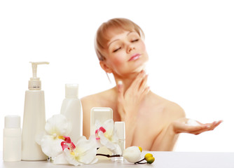 Obraz na płótnie Canvas A young woman applying cream on her skin