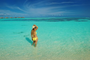 asian woman resting on sand at beach