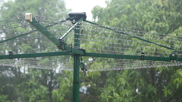 Clothes line in the pouring rain with water droplets