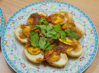 Fried boiled eggs pour with tamarind sauce, Thai's style food