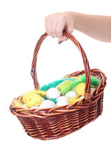 Fototapeta na wymiar basket with easter eggs in female hand