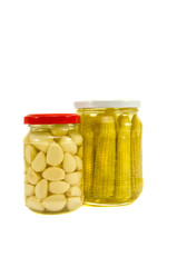 pickled garlic and corn cobs in glass jar