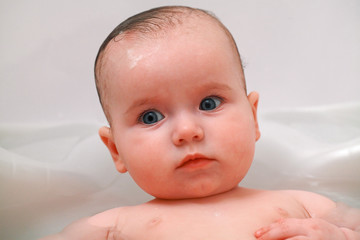 Cute baby girl having a bath