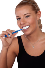 Beautiful woman brushing her teeth