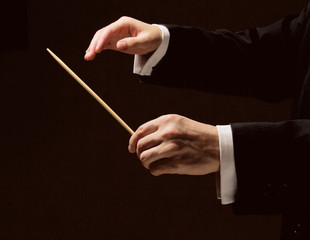 Concert conductor's hands with a baton isolated