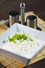 Bowl with fresh cottage cheese and chives