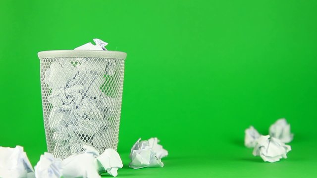 paper ball throwing into basket on green screen