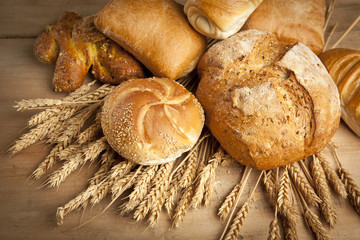 assortment of fresh baked bread on wood table