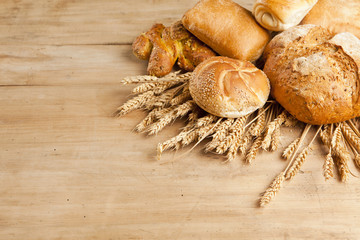 assortment of fresh baked bread on wood table