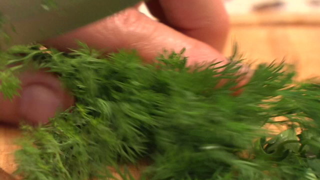 cutting dill in the kitchen