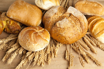 assortment of fresh baked bread on wood table