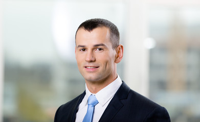 Fototapeta premium Portrait of businessman wearing blue tie