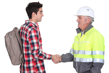 Builder welcoming apprentice