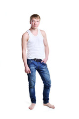 Fototapeta premium Full length of a cute young man in jeans and t-shirt looking at
