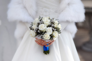 bride hands holding beautiful wedding bouquet