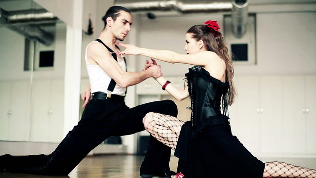 Montage of professional dancers dancing tango in ballroom
