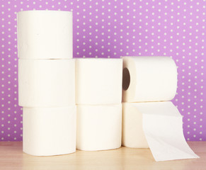 Rolls of toilet paper on purple with dots background