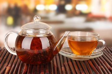 Exotic green tea with flowers in glass teapot