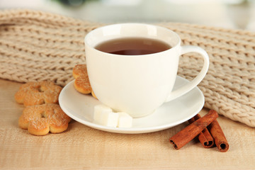 cup of tea with scarf on table in room