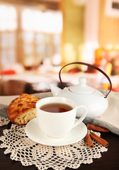 cup of tea with scarf on table in room