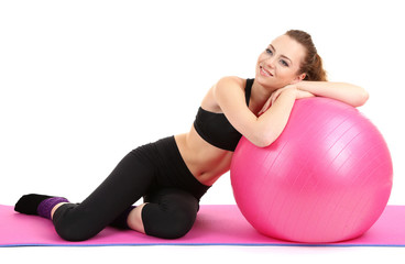 Fototapeta premium Young woman with gym ball isolated on white
