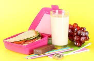 Lunch box with sandwich,grape,milk and stationery