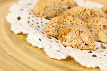 Aromatic cookies cantuccini on wooden plate close-up