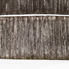 plank wooden wall in winter, snow on the ground