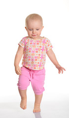 Funny baby girl running on white background