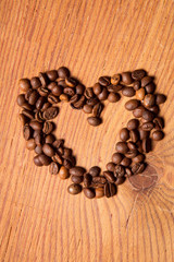 coffee beans in the form of heart on a wooden table