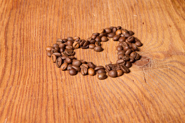 coffee beans in the form of heart on a wooden table