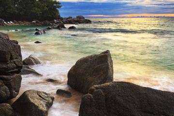Sea waves lash line impact rock on the beach