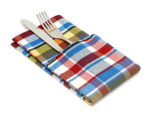 fork and knife in colorful napkin on the white