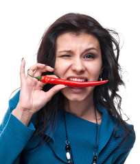 Young girl tasting chili pepper