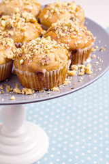Banana muffins with walnuts and white chocolate on a cake stand