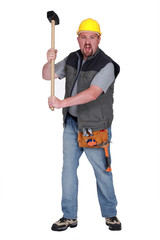 Angry construction worker with sledge-hammer