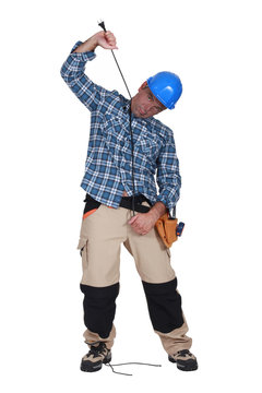 Electrician hanging himself on a wire