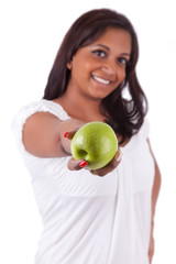 Young happy indian woman holding an apple