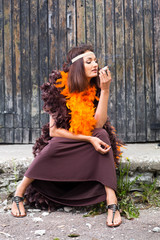 smoking actress in brown and orange boa