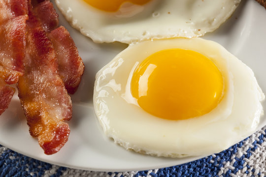 Organic Sunnyside up Egg with toast and bacon