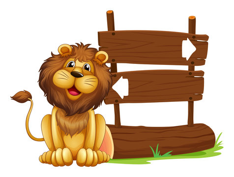 A lion sitting beside a signboard