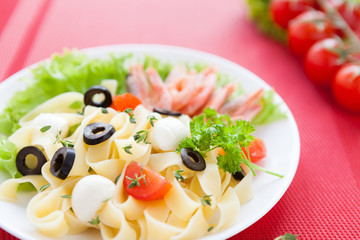 appetizing pasta with prawns and cherry tomatoes