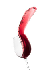 red wine splashing out of a glass, isolated on white