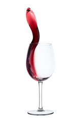 red wine splashing out of a glass, isolated on white